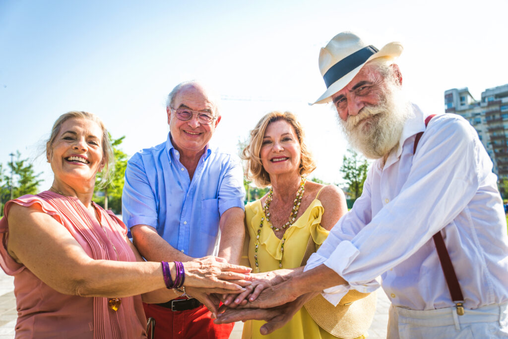 Group of youthful seniors having fun outdoors - Four pensioners bonding outdoors, concepts about lifestyle and elderly